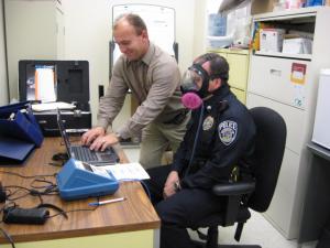 Police officer testing a respirator.